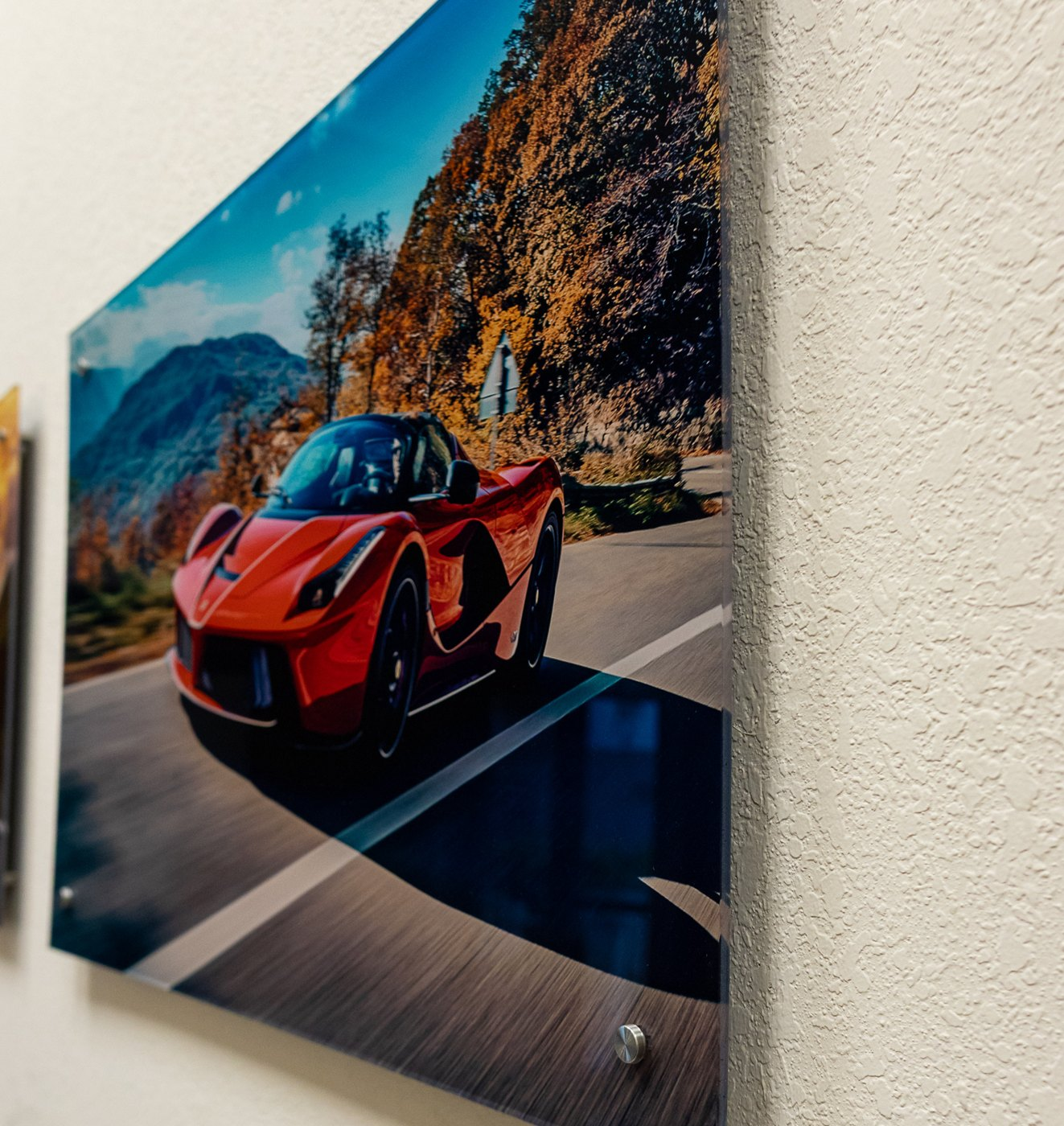 Acrylic print of a red Ferrari floating off the wall on polished standoff mounts