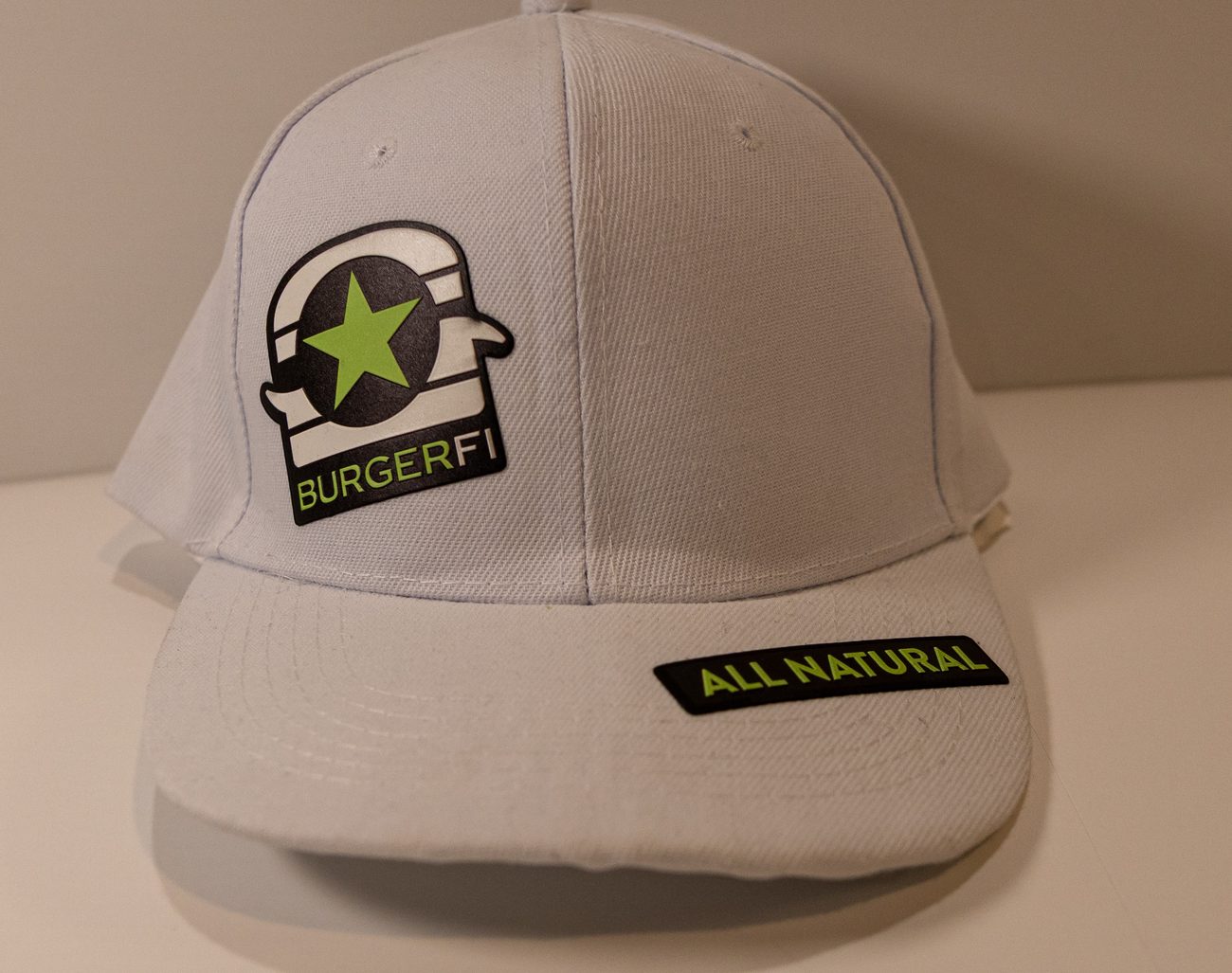 White BurgerFi cap finished with a 3D UV patch and an All Natural tag
