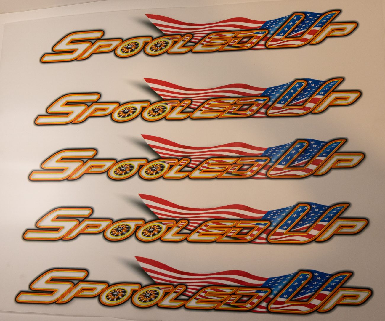 A run of Spooled Up 3D UV patches laid out on the sheet