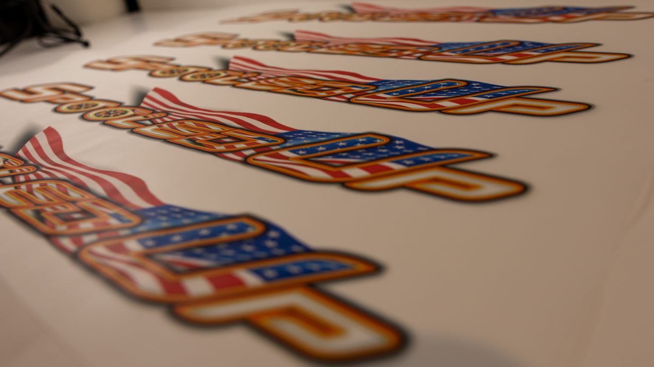 A run of Spooled Up 3D UV patches on the sheet