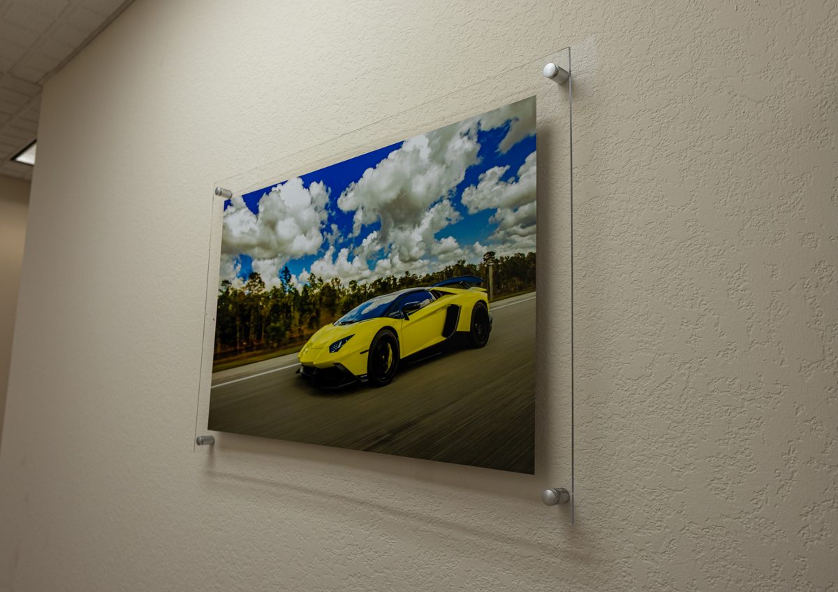 Acrylic print of a yellow Lamborghini on polished standoff mounts