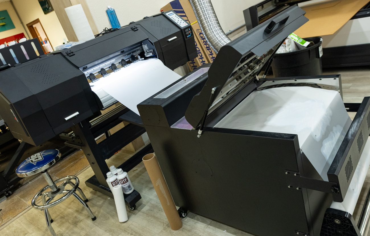 The DTF printer running transfers in the shop