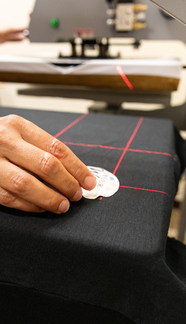 Placing a patch on a shirt under the heat press laser guides