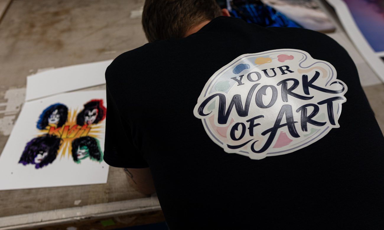 One of the crew at the press wearing the Your Work of Art shirt